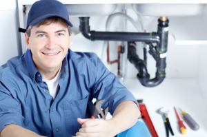 A Salinas plumbing team member sits in front of a recently fixed sink