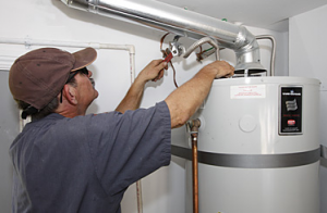 A Salinas water heater repair technician reattaches the intake
